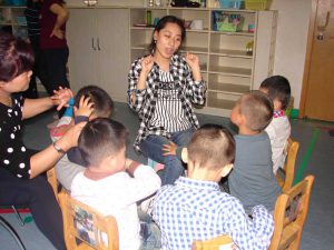 At the Amity Children's Development Centre, Nanjing. Teacher and Classroom Assistant working with pre-school children with autism.
